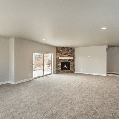 Freshly cleaned carpet in living room with fireplace