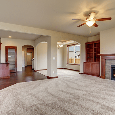 Living room with clean carpet and hardwood floor